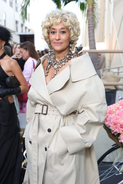 Tracee Ellis Ross wearing an oversized trench coat and a short curly blonde hairstyle
